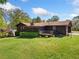 Charming single-story home with a screened-in porch, wooden deck, and a well-manicured lawn at 4927 Bedell Ne Rd, Roswell, GA 30075