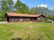Ranch-style house on expansive lawn featuring mature trees and side carport at 4927 Bedell Ne Rd, Roswell, GA 30075