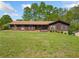 Ranch-style home featuring a well-manicured lawn and verdant landscaping, offering great curb appeal at 4927 Bedell Ne Rd, Roswell, GA 30075