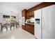 Classic eat-in kitchen with dark wood cabinetry and modern white appliances at 4927 Bedell Ne Rd, Roswell, GA 30075