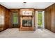 Living room featuring cozy brick fireplace with natural lighting at 4927 Bedell Ne Rd, Roswell, GA 30075