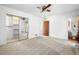 Spacious bedroom featuring neutral carpeting, a ceiling fan, an attached bath, and a large closet at 4927 Bedell Ne Rd, Roswell, GA 30075