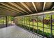 Screened-in porch provides views of the large yard, green grass, mature trees, and storage shed at 4927 Bedell Ne Rd, Roswell, GA 30075