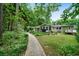 Expansive backyard with lush greenery, a patio, and mature trees at 5839 Darry Cir, Norcross, GA 30093