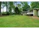 A large, level backyard with green grass and a deck on the rear of the house at 5839 Darry Cir, Norcross, GA 30093