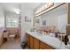 Well-lit bathroom with a long vanity, ample counter space, and classic tile at 5839 Darry Cir, Norcross, GA 30093