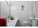 Bathroom with a modern vanity, decorative cross, and ample lighting at 5839 Darry Cir, Norcross, GA 30093