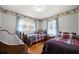 Shared bedroom featuring two cozy beds, hardwood floors, and natural light at 5839 Darry Cir, Norcross, GA 30093