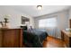 Comfortable bedroom features a patterned comforter, hardwood floors, and bright window at 5839 Darry Cir, Norcross, GA 30093