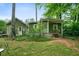 Charming cottage with a covered porch nestled in a lush, green yard at 5839 Darry Cir, Norcross, GA 30093