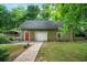 A garage with a red door and attached carport at 5839 Darry Cir, Norcross, GA 30093
