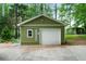 A detached one-car garage with a white door and olive green siding at 5839 Darry Cir, Norcross, GA 30093
