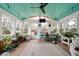 Bright sunroom featuring a striking ceiling, ceiling fan, and an abundance of windows at 5839 Darry Cir, Norcross, GA 30093