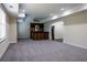 Finished basement featuring neutral carpet, tray ceiling, and a built-in bar for entertaining at 610 Big Bend Trl, Sugar Hill, GA 30518