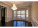 Dining area with large bay window and decorative chandelier, with dark hardwood floors and white trim at 610 Big Bend Trl, Sugar Hill, GA 30518