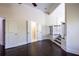 Hallway with hardwood floors with doorways to other rooms and a staircase with iron railings at 610 Big Bend Trl, Sugar Hill, GA 30518