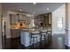 Open kitchen with granite countertops, stainless appliances, custom cabinetry, and a central island with bar stool seating at 610 Big Bend Trl, Sugar Hill, GA 30518