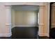Inviting living area featuring decorative columns, dark hardwood floors, and natural light at 610 Big Bend Trl, Sugar Hill, GA 30518