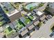 Aerial view shows rooftop patios, community pool, and nearby street of this neighborhood at 6135 Redwine St, Norcross, GA 30071