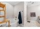 Elegant bathroom with a soaking tub, wood shelving, and a separate shower with stylish gray tiling at 6135 Redwine St, Norcross, GA 30071