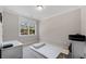 Minimalist bedroom with a window providing natural light and neutral colored walls at 6135 Redwine St, Norcross, GA 30071