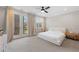 Bright bedroom with a modern ceiling fan, large windows, and french doors opening to a balcony at 6135 Redwine St, Norcross, GA 30071