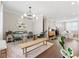 Open-concept dining room featuring a glass-top table, contemporary lighting, and hardwood flooring at 6135 Redwine St, Norcross, GA 30071