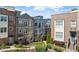 Exterior shot of townhomes, complemented by lush landscaping and walking paths at 6135 Redwine St, Norcross, GA 30071