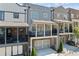 Townhome with gray siding, brick accents, and balcony with black railings above garage at 6135 Redwine St, Norcross, GA 30071