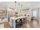 Open kitchen featuring white cabinets, stainless steel appliances, and a large center island with seating at 6135 Redwine St, Norcross, GA 30071