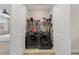 Laundry room with side-by-side washer and dryer and overhead shelving at 6135 Redwine St, Norcross, GA 30071