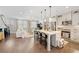 Open-concept living space featuring hardwood floors, modern furnishings, and a connected kitchen at 6135 Redwine St, Norcross, GA 30071
