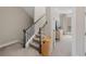 Carpeted staircase with dark wood handrail and white banister at 6135 Redwine St, Norcross, GA 30071