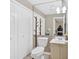 Neutral bathroom featuring dual closet, vanity, sink, and toilet at 992 Old Holcomb Bridge Rd, Roswell, GA 30076