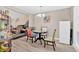Open-concept dining area adjacent to living room with vinyl floors at 992 Old Holcomb Bridge Rd, Roswell, GA 30076