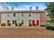 Charming townhome row with red front doors and well-maintained landscaping at 992 Old Holcomb Bridge Rd, Roswell, GA 30076