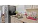 Kitchen sink, stainless steel refrigerator, and white upper cabinets at 992 Old Holcomb Bridge Rd, Roswell, GA 30076