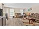 Spacious living room with vinyl floors and a large brown sofa and accent rug at 992 Old Holcomb Bridge Rd, Roswell, GA 30076