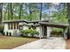 Inviting home with a carport, updated windows, lush landscaping, and a well-maintained lawn at 1587 Wainwright Se Dr, Atlanta, GA 30316