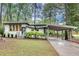 Charming single story home with a carport, complemented by lush landscaping and mature trees at 1587 Wainwright Se Dr, Atlanta, GA 30316
