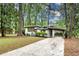 Mid-century modern exterior featuring covered carport, well-manicured lawn, and mature trees at 1587 Wainwright Se Dr, Atlanta, GA 30316