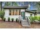Inviting front entrance featuring a gray brick foundation, blue accent door and lovely plantings at 1587 Wainwright Se Dr, Atlanta, GA 30316
