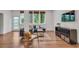 Spacious living room featuring hardwood floors, a blue sofa and a modern entertainment center at 1587 Wainwright Se Dr, Atlanta, GA 30316