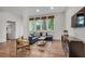 Inviting living room featuring a plush sectional, hardwood floors, and a view of the kitchen at 1587 Wainwright Se Dr, Atlanta, GA 30316