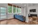Elegant living room showcasing a modern sofa and a view of the outdoors through large windows at 1587 Wainwright Se Dr, Atlanta, GA 30316
