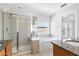 Bright bathroom with tile floors, glass shower, soaking tub, and granite-topped wooden vanity at 2775 Loftview Sq # 8, Atlanta, GA 30339