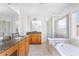 Bathroom with dual vanities, soaking tub, glass-enclosed shower, and tile flooring at 2775 Loftview Sq # 8, Atlanta, GA 30339