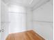 Walk-in closet with white wire shelving, hardwood floors, and ample storage space at 2775 Loftview Sq # 8, Atlanta, GA 30339