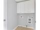 Simple laundry room has overhead cabinets, tile floors, and hookups at 2775 Loftview Sq # 8, Atlanta, GA 30339