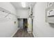 Unfinished basement utility area with water heater, exposed ductwork, wood-look floors, and storage shelving at 2988 Chipmunk Se Trl, Marietta, GA 30067